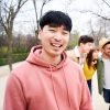 young-smiling-asian-guy-looking-at-the-camera-outd-2025-01-07-23-11-16-utc Young smiling asian guy looking at the camera outdoors with group of friends. Happy people having fun together Focus on a young Chinese man. University Colleagues at campus.